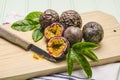 Passion fruits with leaves, knife and white flowers in jar Royalty Free Stock Photo