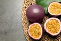 Passion fruits maracuyas and green leaf on grey table. Space for text Royalty Free Stock Photo