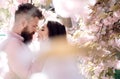 Passion and love concept. Man and woman kissing in blooming garden on spring day. Couple in love spend time in spring Royalty Free Stock Photo