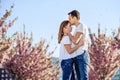 Passion and love concept. Man and woman kissing in blooming garden on spring day. Couple hugs near sakura trees. Couple Royalty Free Stock Photo