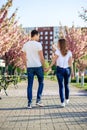 Passion and love concept. Man and woman kissing in blooming garden on spring day. Couple hugs near sakura trees. Couple Royalty Free Stock Photo