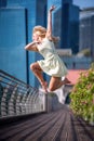 Passionate beautiful blonde female dancer jumps high in the air,