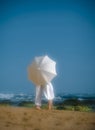 Passionate couple on beach behind white umbrella Royalty Free Stock Photo