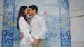 Passionate couple dancing at azulejo place closeup. Pair holding hands embracing