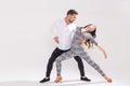 Passionate couple dancing social danse kizomba or bachata or semba or taraxia on white background with copy space Royalty Free Stock Photo