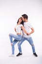 Passionate couple dancing social danse kizomba or bachata or semba or taraxia on white background Royalty Free Stock Photo