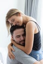 Passionate couple is hug and kiss on bed in their white bedroom Royalty Free Stock Photo