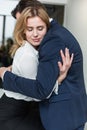 Passionate couple hugging and having a love affair in the office. Workplace flirt or romance. Business man and woman are Royalty Free Stock Photo