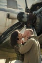 Passionate couple kissing, boy and girl. Couple kissing in front of propeller of old plane on sunny day. Couple in love Royalty Free Stock Photo