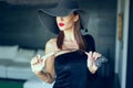 Passionate dominant femme fatale in hat with whip portrait Royalty Free Stock Photo