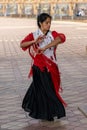 Passionate flamenco dancer woman in colorful clothes dancing at the Plaza de Espana in Seville