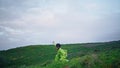 Passionate girl artist dancing on cloudy evening field. Dancer performing modern