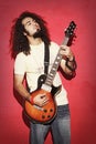 Passionate guitarist with beautiful long curly hair playing guitarist Royalty Free Stock Photo