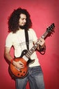 Passionate guitarist happy with beautiful long curly hair playing guitarist Royalty Free Stock Photo