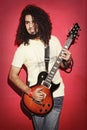 Passionate guitarist playing with beautiful long curly hair play Royalty Free Stock Photo