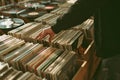 Hand picking old vinyl records from a shelf in a book store.