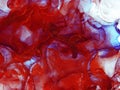 Passionate red abstract fluid art painting. Transparent overlayers of alcohol inks.