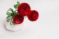 Passionate red flowers in white vase on wood background. Valentine day concept for design. Royalty Free Stock Photo