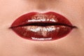 Passionate red glossy lips, closeup of beautiful female mouth with sparkling makeup