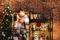 Passionate romantic caucasian couple in sweaters are spending time together before New Year at home. Tender couple