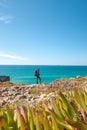 Passionate young backpacker tracks rocky cliffs on the Atlantic coast near Vila Nova de Milfontes, Odemira, Portugal. In the