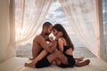 Passionate young couple sitting on the beach