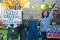 Young kids with their parents at peaceful School Student Climate Change Protest