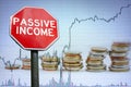 Passive income stop road sign on economy background with graph and coins