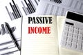 PASSIVE INCOME text written on a notebook on chart and diagram