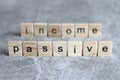 Passive income word written on wood cube