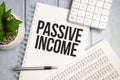 Passive Income Words on notebook and calculator with charts Royalty Free Stock Photo