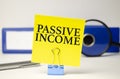 Passive Income Words on yellow sticker and blue folder Royalty Free Stock Photo