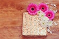 Passover background. matzoh (jewish passover bread) and flowers on wooden table Royalty Free Stock Photo