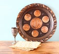 Passover background plate, wine and matzoh jewish passover bread over wooden background Royalty Free Stock Photo