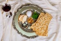 Passover background with wine bottle, matzoh, egg and seder plate Royalty Free Stock Photo