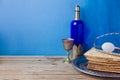 Passover background with wine, matzoh and egg over blue wall Royalty Free Stock Photo