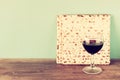 Passover background. wine and matzoh (jewish passover bread) over wooden background. Royalty Free Stock Photo