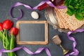 Passover holiday concept seder plate, matzoh and chalkboard on dark background. Top view Royalty Free Stock Photo