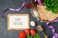 Passover holiday concept seder plate, matzoh and photo frame on dark background. Royalty Free Stock Photo