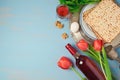 Passover holiday concept seder plate, matzoh and tulip flowers on wooden background.