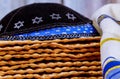 Passover matzoh jewish holiday bread with kipah and tallit over wooden table