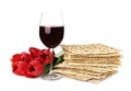 Passover matzos, glass of wine and flowers on background. Pesach celebration Royalty Free Stock Photo