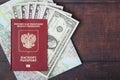 A passport with american dollar banknotes inside as work and travelling concept Royalty Free Stock Photo