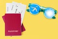 Passport, boarding pass, flight ticket, sunglasses, airplane, shiny sun in blue sky, yellow background, summer holidays, travel Royalty Free Stock Photo