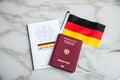 Passport and constitution basic law book of Germany with flag on marble background