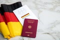 Passport and constitution basic law book of Germany with flag on marble background
