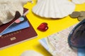 Passport, credit card, travel accessories, seashells. Vacation documents. Turism concept. Selective focus.