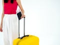 Passport with flight ticket in women`s hand in pink sleeveless while she holding a suitcase. Royalty Free Stock Photo