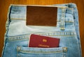 Passport inside denim jeans pocket with brown leather tag Royalty Free Stock Photo