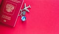 Passport for international flights, toy airplane, globe and hand luggage on red background Royalty Free Stock Photo